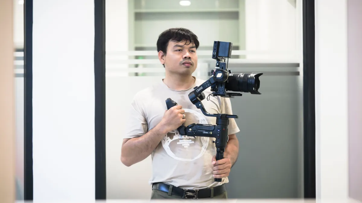 Gimbal vs tripod: which one should you use for video? Person holding a camera on a gimbal stabilizer